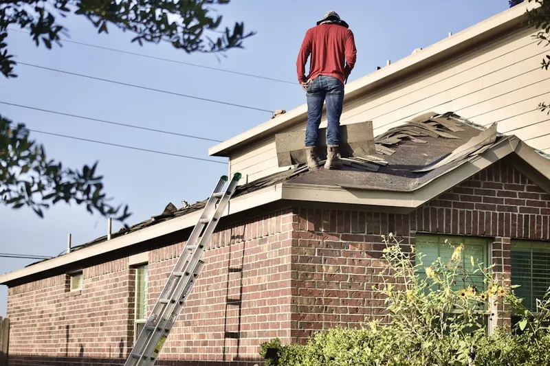 Professional roofer working on a residential roof in Vista